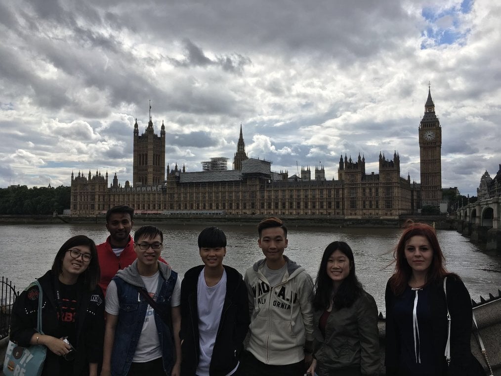 CP A group of interns stand on a bridge in London with Big Ben in the background.